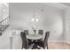 Cozy dining area with a round table, four chairs, and stairway access, adjacent to other rooms at 1005 S Miller Way, Lakewood, CO 80226