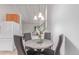 Dining area with a round table, four chairs, and stairway, next to an open kitchen at 1005 S Miller Way, Lakewood, CO 80226