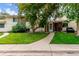 Charming townhome with a manicured lawn and inviting walkway leading to the front entrance at 1005 S Miller Way, Lakewood, CO 80226