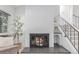 White brick fireplace with glass fireplace, staircase and comfortable seating in the living room at 1005 S Miller Way, Lakewood, CO 80226