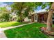Inviting home featuring a well-manicured lawn and mature trees, perfect for outdoor enjoyment and curb appeal at 1005 S Miller Way, Lakewood, CO 80226