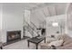 Airy living room with white brick fireplace and staircase open to the dining area with modern decor at 1005 S Miller Way, Lakewood, CO 80226