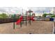 Community playground with slides, climbing structures, and wood chip ground covering at 1005 S Miller Way, Lakewood, CO 80226