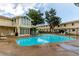 Community swimming pool with lounge chairs and well-maintained deck area near townhomes at 1005 S Miller Way, Lakewood, CO 80226