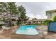 Community swimming pool with lounge chairs, trees, and townhome views at 1005 S Miller Way, Lakewood, CO 80226