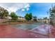 Community tennis court with basketball hoops surrounded by greenery and townhomes at 1005 S Miller Way, Lakewood, CO 80226