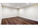 Finished basement area with vinyl floors and neutral color scheme at 703 S Depew St, Lakewood, CO 80226