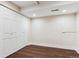 Basement bedroom with closet, dark wood laminate flooring, recessed lighting, and white trim at 703 S Depew St, Lakewood, CO 80226