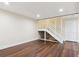 Finished basement with dark wood laminate flooring, white trim, recessed lighting, and white stairs at 703 S Depew St, Lakewood, CO 80226