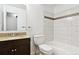 Bathroom with modern fixtures, granite countertops, and tiled shower at 703 S Depew St, Lakewood, CO 80226