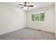 Bright bedroom featuring a window, neutral walls, and carpeted flooring at 703 S Depew St, Lakewood, CO 80226