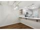 Bright dining area with modern lighting and an open view into the kitchen at 703 S Depew St, Lakewood, CO 80226