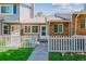 Inviting townhome featuring a cozy, fenced front yard and well-kept lawn at 703 S Depew St, Lakewood, CO 80226
