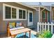 Cozy front porch with bench seating and a view of the front door at 703 S Depew St, Lakewood, CO 80226
