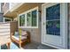 Cozy front porch with bench seating and a view of the front door at 703 S Depew St, Lakewood, CO 80226