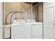 Basement laundry room with utility tub and standard washer and dryer at 703 S Depew St, Lakewood, CO 80226