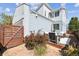 The fenced backyard features a nice seating area with a wooden gate entrance at 6777 Mariposa St, Denver, CO 80221