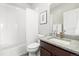 Well-lit bathroom with a shower-tub combo and granite-topped vanity at 6777 Mariposa St, Denver, CO 80221