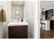 A neat half-bathroom with a stylish mirror and a modern vanity at 6777 Mariposa St, Denver, CO 80221