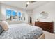 Bright bedroom with large windows, dresser, and ceiling fan, offering a comfortable retreat at 6777 Mariposa St, Denver, CO 80221