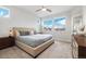 Comfortable bedroom with a large bed, soft carpet, and plenty of natural light at 6777 Mariposa St, Denver, CO 80221