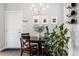 A cozy dining room is enhanced with a modern chandelier and a stylish wine rack at 6777 Mariposa St, Denver, CO 80221