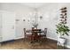 Bright dining area with a modern chandelier, a sleek wine rack, and warm wood floors at 6777 Mariposa St, Denver, CO 80221