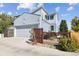 Exterior of home with a garage, wooden fence, and partial view of a seating area at 6777 Mariposa St, Denver, CO 80221