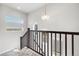 Bright hallway featuring wooden staircase and ample natural light from multiple windows at 6777 Mariposa St, Denver, CO 80221