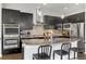 Sleek kitchen with dark cabinetry, granite countertops, and modern stainless steel appliances at 6777 Mariposa St, Denver, CO 80221