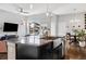 A beautifully appointed kitchen island featuring granite countertops and a stainless steel farmhouse sink at 6777 Mariposa St, Denver, CO 80221