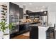 Contemporary kitchen with dark cabinets, granite countertops, and stainless steel appliances at 6777 Mariposa St, Denver, CO 80221