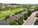 Expansive aerial view of a home nestled adjacent to the lush green fairways of a scenic golf course at 1001 Deer Clover Way, Castle Pines, CO 80108