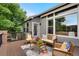 Cozy back deck featuring outdoor seating and a colorful floral arrangement, perfect for relaxation at 1001 Deer Clover Way, Castle Pines, CO 80108