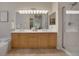 Well-lit bathroom featuring a double sink vanity with neutral-toned cabinets and a walk-in shower at 1001 Deer Clover Way, Castle Pines, CO 80108