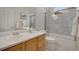 Well-lit bathroom featuring a shower over bath, a white countertop, and wood cabinets at 1001 Deer Clover Way, Castle Pines, CO 80108