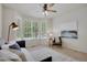 Bright bedroom with neutral walls, a ceiling fan, and large windows overlooking the outdoors at 1001 Deer Clover Way, Castle Pines, CO 80108