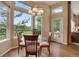 Bright dining area with hardwood floors and a large window showcasing the golf course view at 1001 Deer Clover Way, Castle Pines, CO 80108