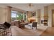 Cozy living room featuring a fireplace, large windows, and comfortable seating at 1001 Deer Clover Way, Castle Pines, CO 80108