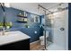 Modern blue bathroom with vanity, walk-in shower and stylish decor at 412 Gemini Ct, Lone Tree, CO 80124