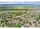 Neighborhood aerial view showcasing solar panels, nearby roadways, and mountain views at 9821 Bucknell Ct, Highlands Ranch, CO 80129