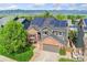 Elevated view featuring the home with solar panels, landscaping, mountain views, and neighborhood at 9821 Bucknell Ct, Highlands Ranch, CO 80129