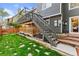 Grassy backyard featuring stairs leading to an upper-level deck at 9821 Bucknell Ct, Highlands Ranch, CO 80129