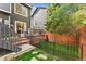 Landscaped backyard with a dining area and a stone grill at 9821 Bucknell Ct, Highlands Ranch, CO 80129