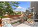 Multi-tiered backyard with a stone bench and stairs to the upper deck at 9821 Bucknell Ct, Highlands Ranch, CO 80129