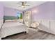Light and bright bedroom with wainscotting and a reading nook at 9821 Bucknell Ct, Highlands Ranch, CO 80129