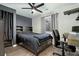 Cozy bedroom featuring a ceiling fan and a dark accent wall at 9821 Bucknell Ct, Highlands Ranch, CO 80129