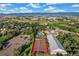 Aerial view featuring the community pool, tennis courts, clubhouse, and parking area at 9821 Bucknell Ct, Highlands Ranch, CO 80129