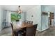 Dining room features a large wooden table, patterned wallpaper, and natural light from a large window at 9821 Bucknell Ct, Highlands Ranch, CO 80129