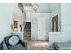 Bright, open foyer featuring hardwood floors, staircase, and stylish decor with light blue walls at 9821 Bucknell Ct, Highlands Ranch, CO 80129